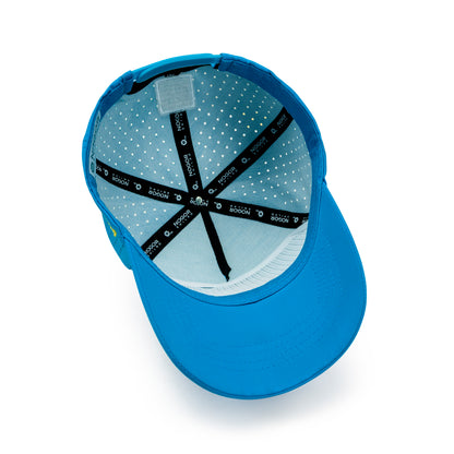 Blue performance cap with Ride The Wave surf patch and yellow Nogor Shilpo side embroidery