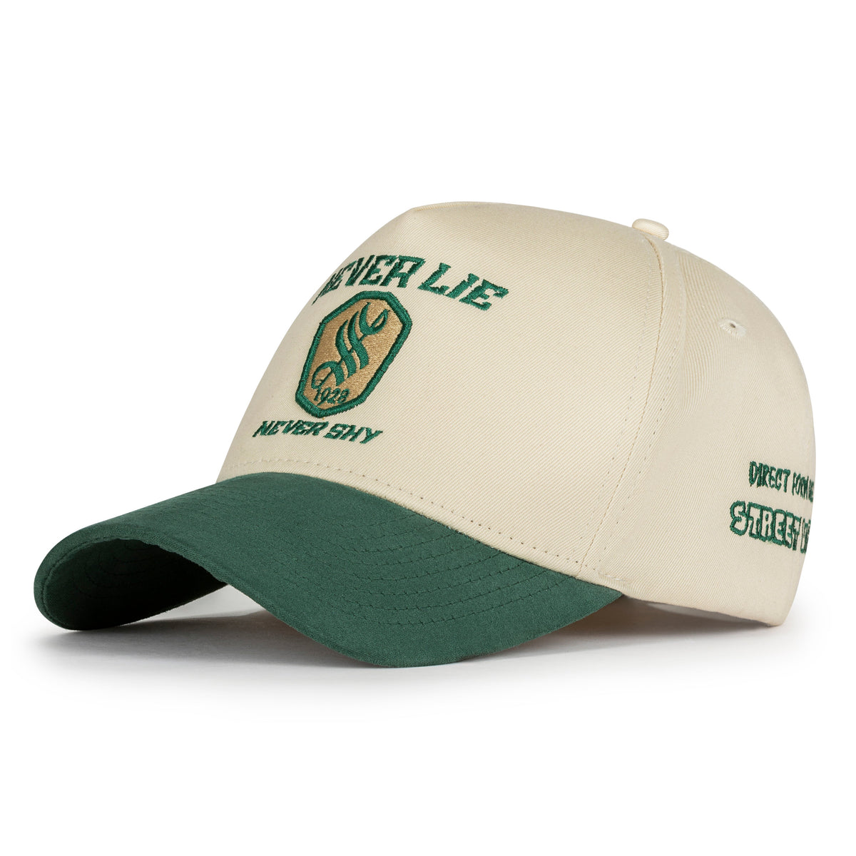 Back view of cream twill cap with rubberized Nogor Shilpo emblem patch, brass buckle and green suede visor